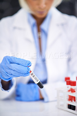 Buy stock photo Cropped shot of a scientist working with blood samples in her lab