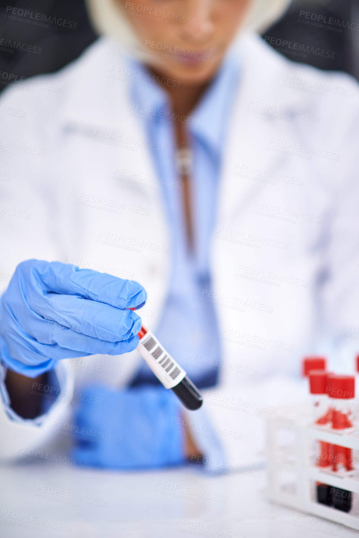 Buy stock photo Cropped shot of a scientist working with blood samples in her lab