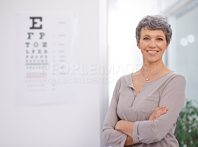 Buy stock photo Woman, smile and portrait of optometrist in office with confidence, eye exam and medical test. Healthcare, mature employee and happy with sight support, wellness and chart for vision assessment