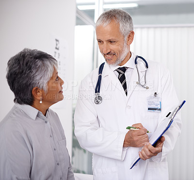 Buy stock photo Senior man doctor with patient, clipboard for information and medical forms during consultation. Healthcare, old woman at checkup and health insurance with communication and help at doctors office