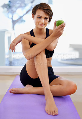 Buy stock photo Portrait, fitness and woman with apple on yoga mat in gym for diet, wellness or weight loss with healthy body. Nutrition, floor and person eating fruit or organic food with vitamin c after exercise