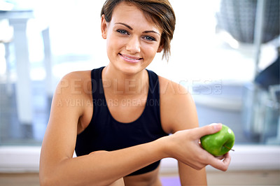 Buy stock photo Portrait, fitness and happy woman with apple in gym for diet, nutrition and wellness with healthy body. Face, exercise and person eating fruit for organic food, vitamin c or benefits after sport