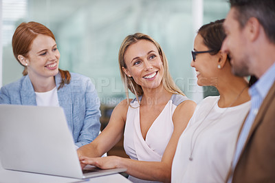 Buy stock photo A diverse group of businesspeople using a laptop at a meeting