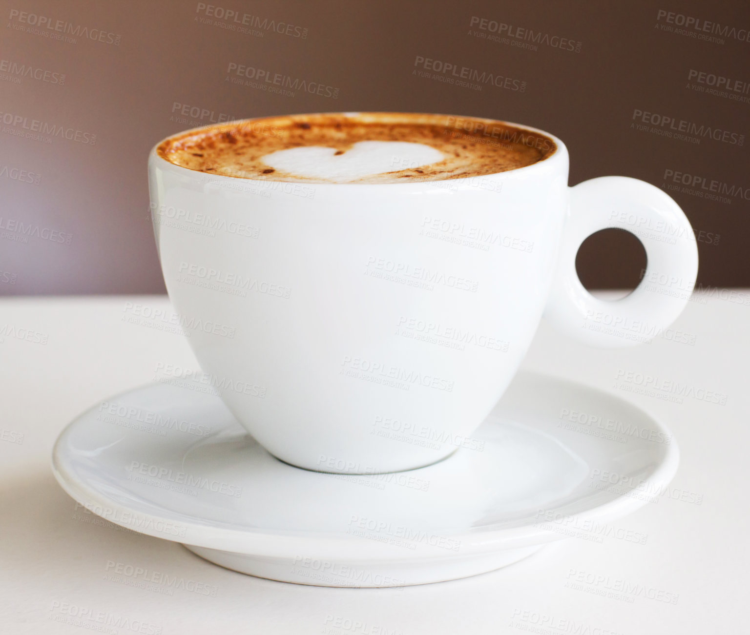 Buy stock photo Shot of a freshly-made cappuccino on a white table