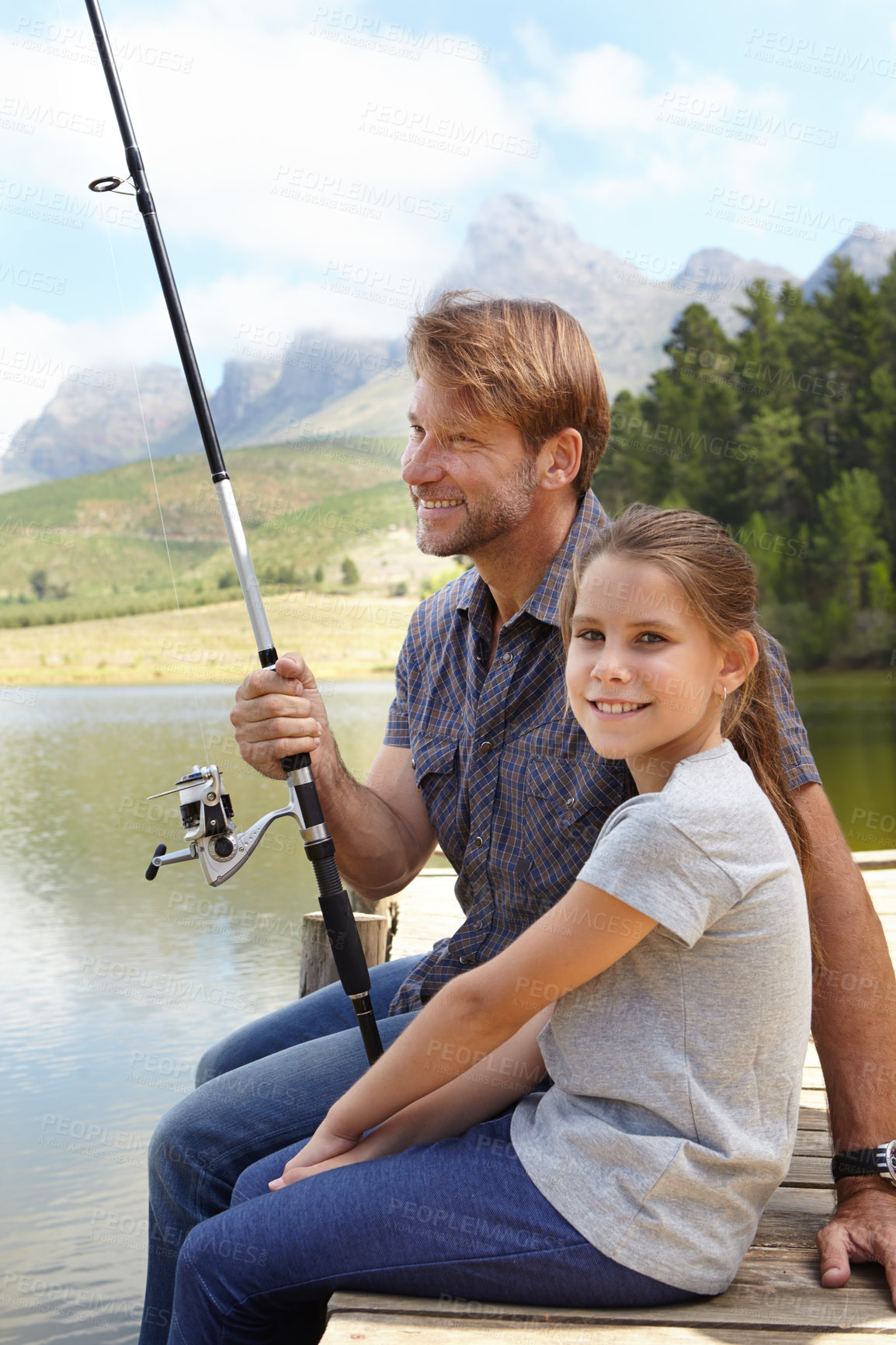 Buy stock photo Father, child and fishing in nature for teaching, learning and outdoor with holiday, travel or sustainable living in portrait. Happy family, dad or fisherman with girl by water or lake for adventure