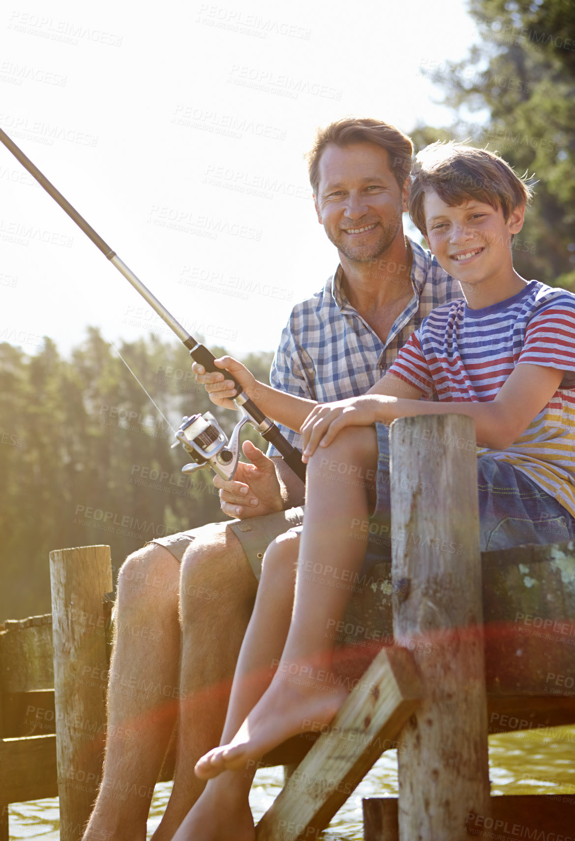 Buy stock photo Cropped shot of a father and son fishing
