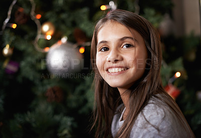 Buy stock photo Shot of a little girl sitting by a christmas tree