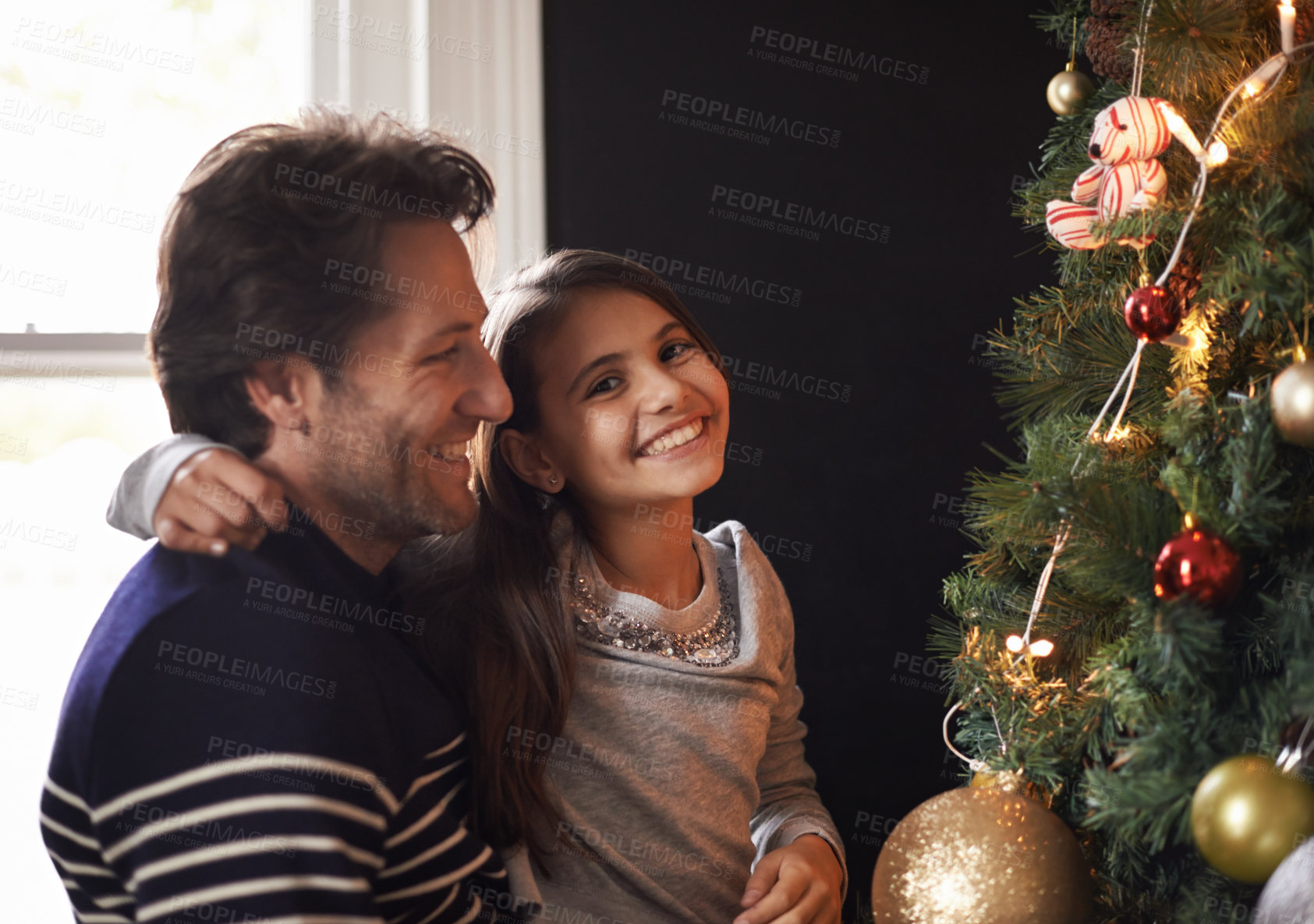 Buy stock photo Portrait, child and dad at tree for Christmas decoration, bonding and fun in family home. Festive, xmas decor and father with girl kid, smile and happy holiday together in care, love and celebration.