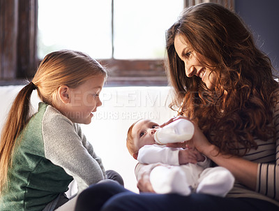 Buy stock photo Mother, newborn and milk feeding with child in a family home with love, support and care together. Smile, relax and bottle for youth development and growth with mom and young girl on living room sofa
