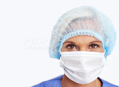 Buy stock photo A portrait of a young doctor in her scrubs and mask