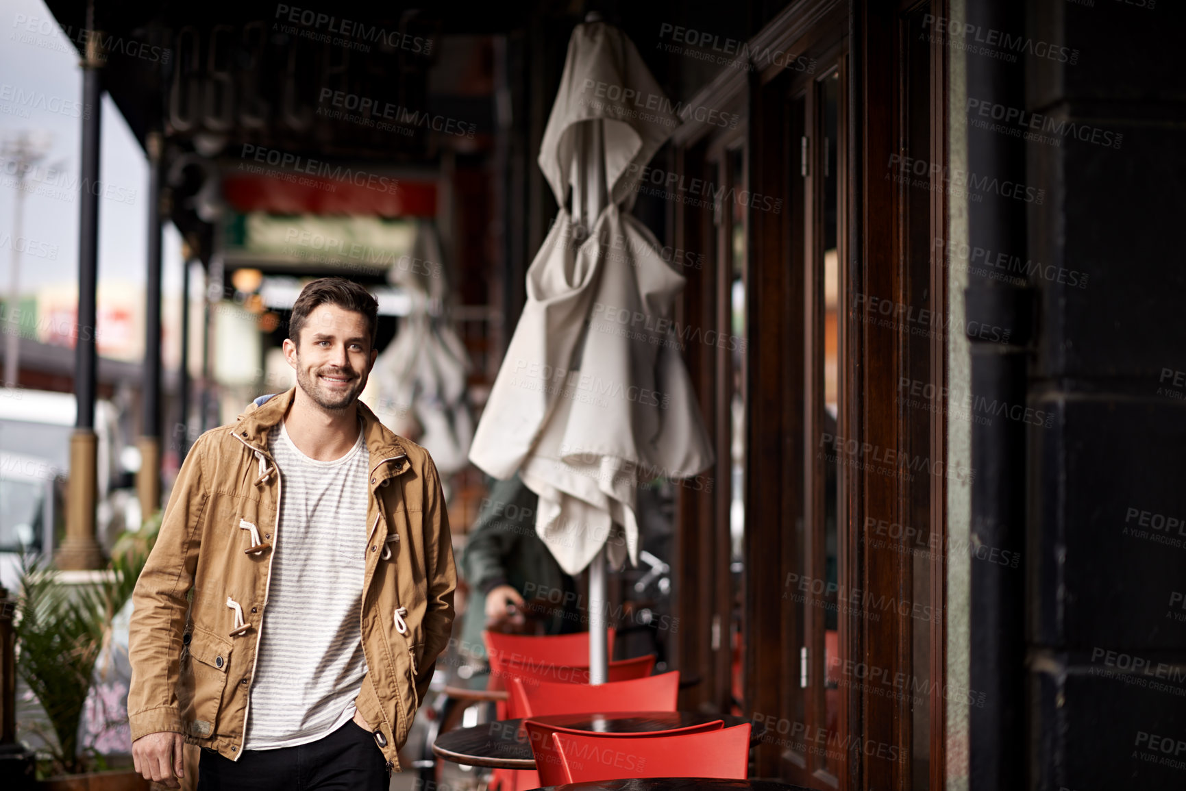 Buy stock photo Cropped shot of a fashionable young man strolling through the city 