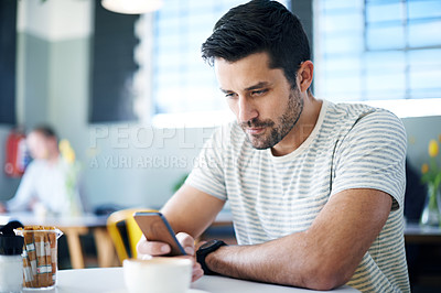 Buy stock photo Man at restaurant, smartphone and scroll on social media, reading on mobile app or ebook with communication and contact. Chat, email or text message with tech, search internet and online at cafe