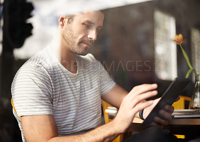 Buy stock photo Man, tablet and coffee shop for networking, online communication and website for information. Male person, cafe and app for conversation, social media and remote work in restaurant for research