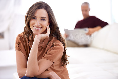 Buy stock photo Woman, smile and portrait at home in the morning on a sofa with relax and calm with husband. Couple, couch and living room with a female person with confidence in a house lounge with newspaper