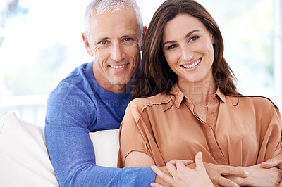 Buy stock photo Portrait of a mature man standing behind his younger wife