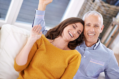 Buy stock photo Couple, portrait and laughing in home for love with support, trust and comic joke in living room of house. Senior man, woman and funny on sofa with embrace, affection and relationship in apartment