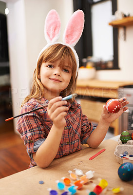 Buy stock photo Happy girl, portrait and paint with easter egg for colorful art, tradition or holiday crafts at home. Young child enjoying color, activity or artwork with smile, paintbrush or bunny ears at the house