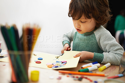Buy stock photo A cute little boy doing crafts at pre-school
