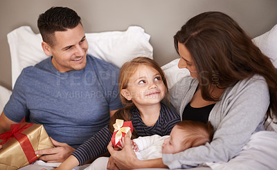 Buy stock photo Bedroom, gift or family with celebration, home or bonding together with happiness, Christmas or festive season. Parents, mother or father with children, excited or kids with presents, morning or Xmas