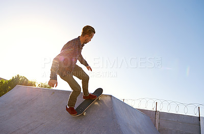 Buy stock photo Skate park, freedom and man with skateboard balance, stunt or bowl trick outdoor for training at sunset. Skating, energy and male skater with ramp action, performance or vacation fun or practice