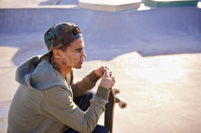 Buy stock photo Thinking, skateboard and man at a skate park with idea for trick, stunt or adrenaline sports action. Planning, calm and male skateboarder with reflection, questions or memory while chilling on a ramp