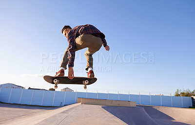 Buy stock photo Sports, fitness and man with skateboard, jump or ramp action at a skate park for stunt training. Freedom, adrenaline and gen z male skater with energy, air or skill practice, exercise or  performance