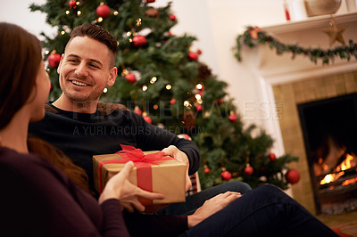 Buy stock photo Christmas, gift and happy family celebration of a man with a present at a holiday party. Couple with love and care on the holidays together with gifting box feeling happiness with a smile at home