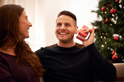 Buy stock photo Couple, Christmas and love with guess gift box for surprise, happiness and holiday excitement. Happy, marriage and present for partner guessing what is inside with cheerful smile in home.