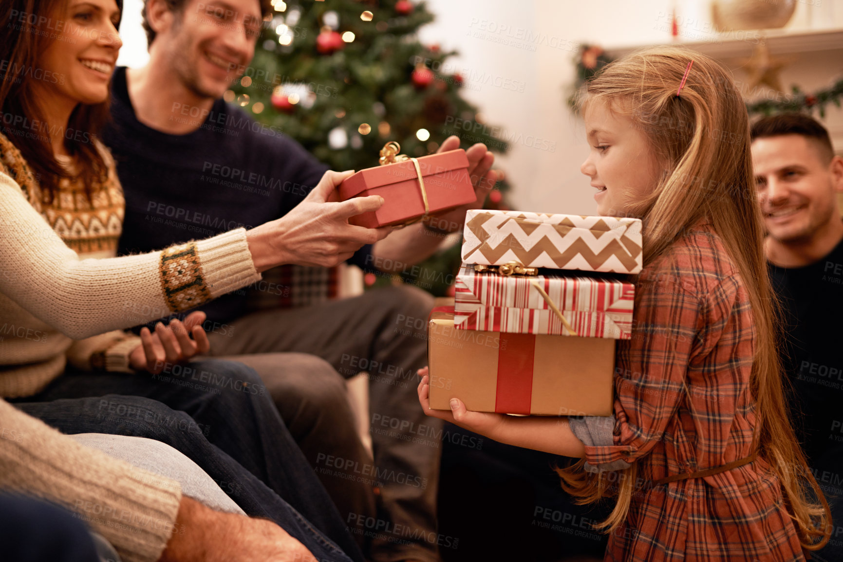 Buy stock photo Shot of a a family giving presents at christmas