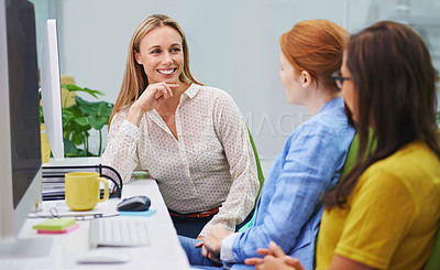 Buy stock photo Shot of an attractive business woman having a discussion with other female coworkers in an office setting