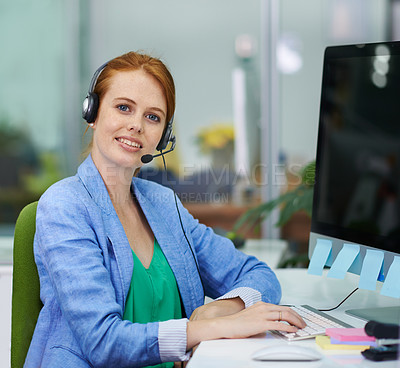 Buy stock photo Shot of an attractive redheaded female businesswoman wearing headsets in an office