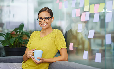 Buy stock photo Attractive female office worker sneaking in a second cup of coffee on her break