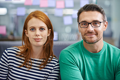 Buy stock photo Two work colleagues sitting together in the office