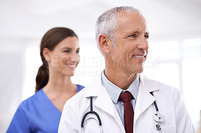 Buy stock photo Doctors, man and woman with smile at clinic for medical support, vision and partnership with ideas. Mature medic, people and nurse in team, happy or health services at hospital for thinking in career