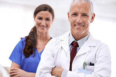 Buy stock photo Doctor, nurse and partnership in portrait with arms crossed, medical support or wellness at hospital. Medic, mature man and woman in team, smile or healthcare services in clinic with pride for career