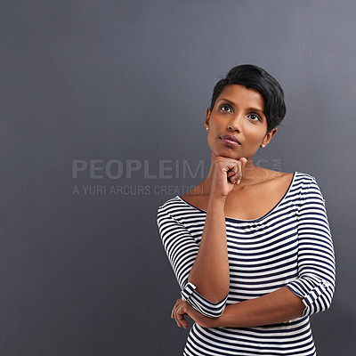 Buy stock photo Woman, thinking and fashion with idea for decision, choice or selection on a gray studio background. Thoughtful female person, Indian or model in wonder or contemplating for solution on mockup space