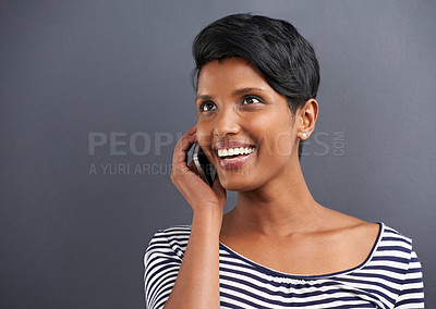Buy stock photo Happy woman, communication and conversation with phone for call on a gray studio background. Young female person with smile and talking on mobile smartphone for friendly discussion on mockup space