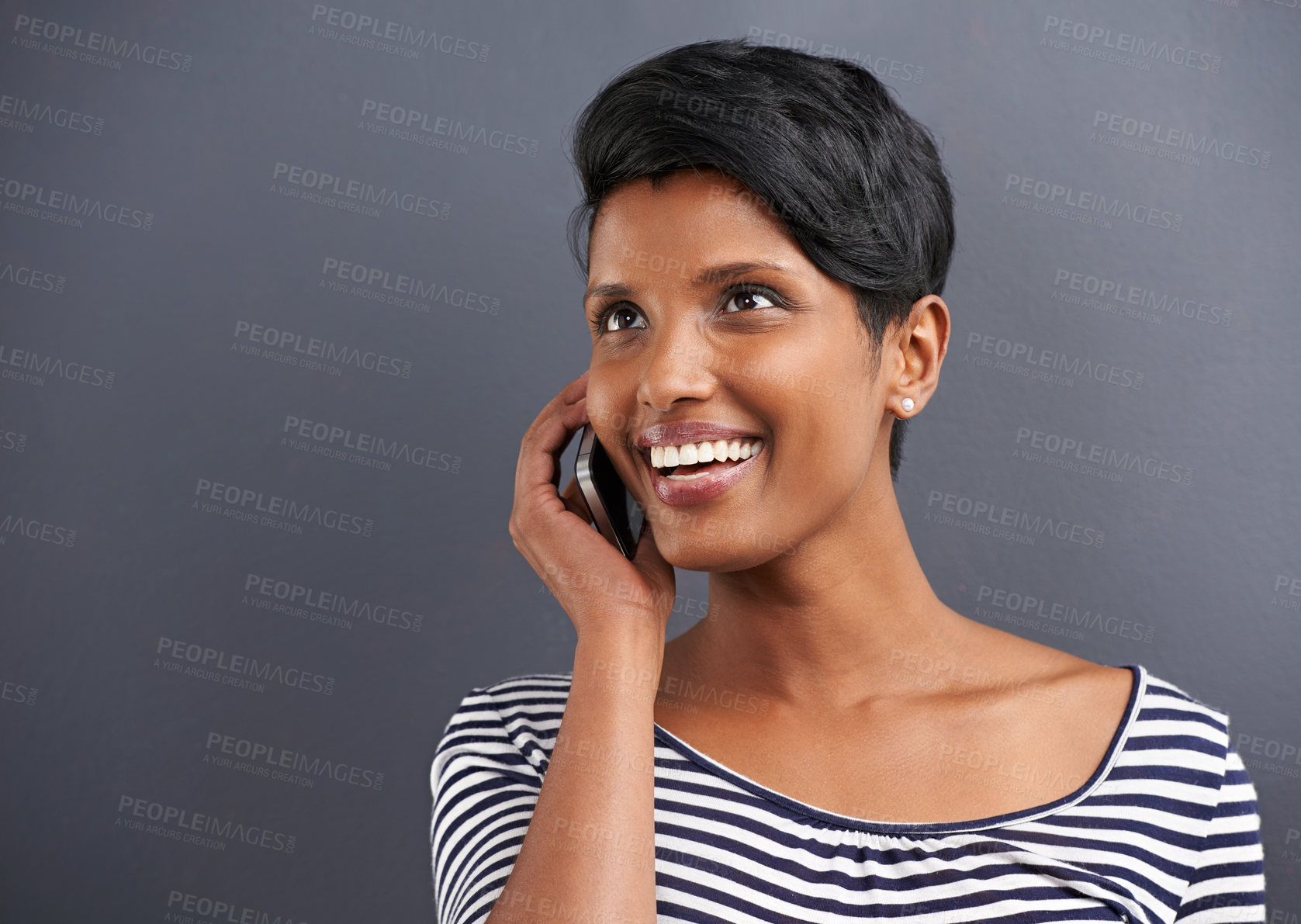 Buy stock photo Happy woman, communication and conversation with phone for call on a gray studio background. Young female person with smile and talking on mobile smartphone for friendly discussion on mockup space
