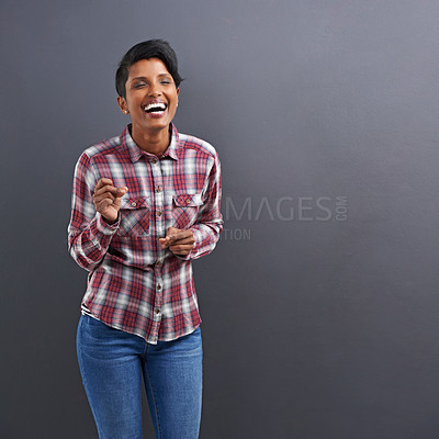 Buy stock photo Studio shot of a beautiful young woman laughing against a grey background