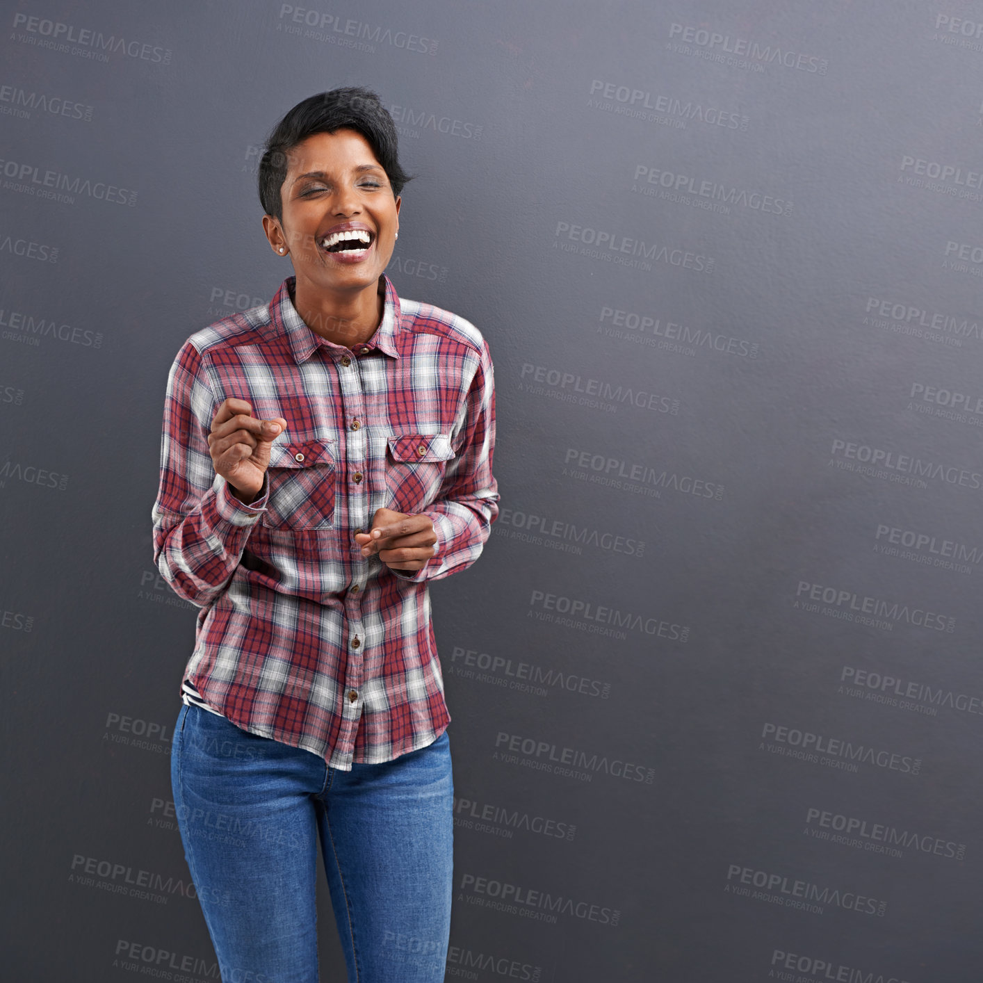 Buy stock photo Studio shot of a beautiful young woman laughing against a grey background