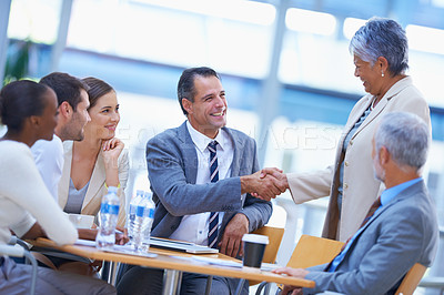 Buy stock photo Coworker, office and handshake with smile for success on deal, teamwork and collaboration. Diverse, boardroom and happy for business achievement with congratulations as ceo or leader of company. 