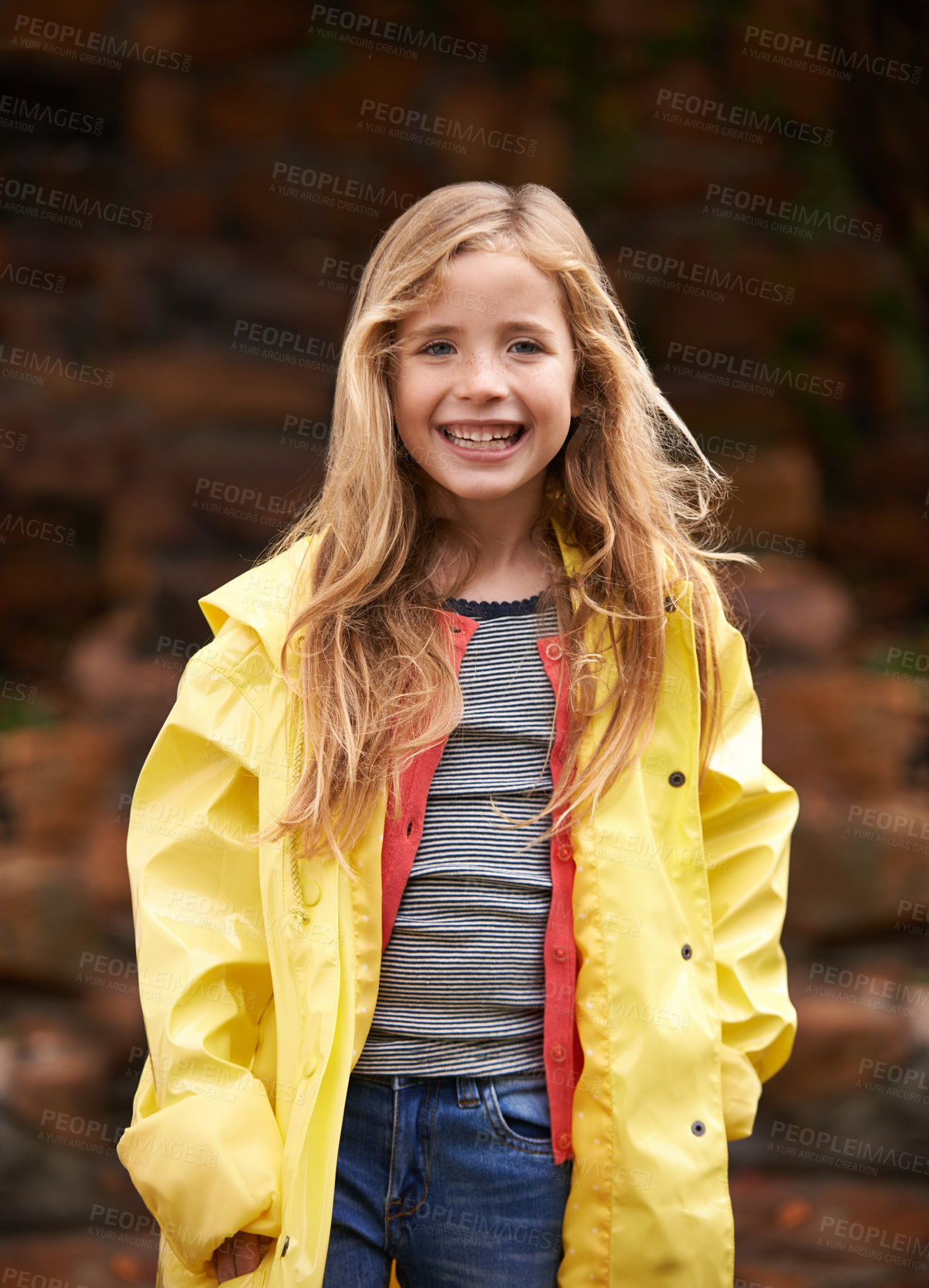 Buy stock photo Portrait, smile and happy girl in raincoat, winter and outdoors for cold weather. Child, joyful or relax in nature for autumn or rain on vacation in Scotland, holiday or outside for youth or travel