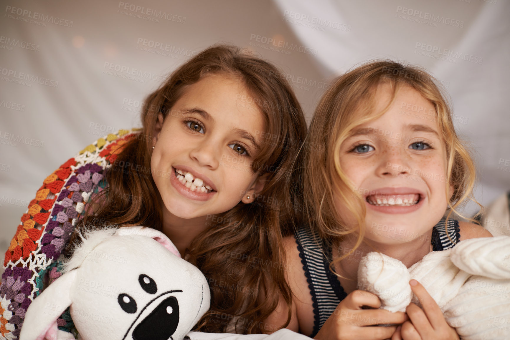 Buy stock photo Happy, sleepover and portrait of kids in bedroom for playing, bonding and relax with toys in home. Excited, friends and young girls on bed in tent or blanket fort for childhood, fun and happiness