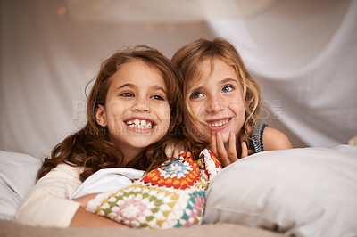 Buy stock photo Happy, sleepover and face of children in bedroom for playing, bonding and relax with toys in home. Laughing, friends and young girls on bed in tent or blanket fort for childhood, fun and happiness