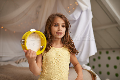 Buy stock photo Girl, child and happy in house with tambourine for playing, music and learning rhythm in bedroom. Kid, instrument and smile for noise, sound and concert for funny games with creativity at family home