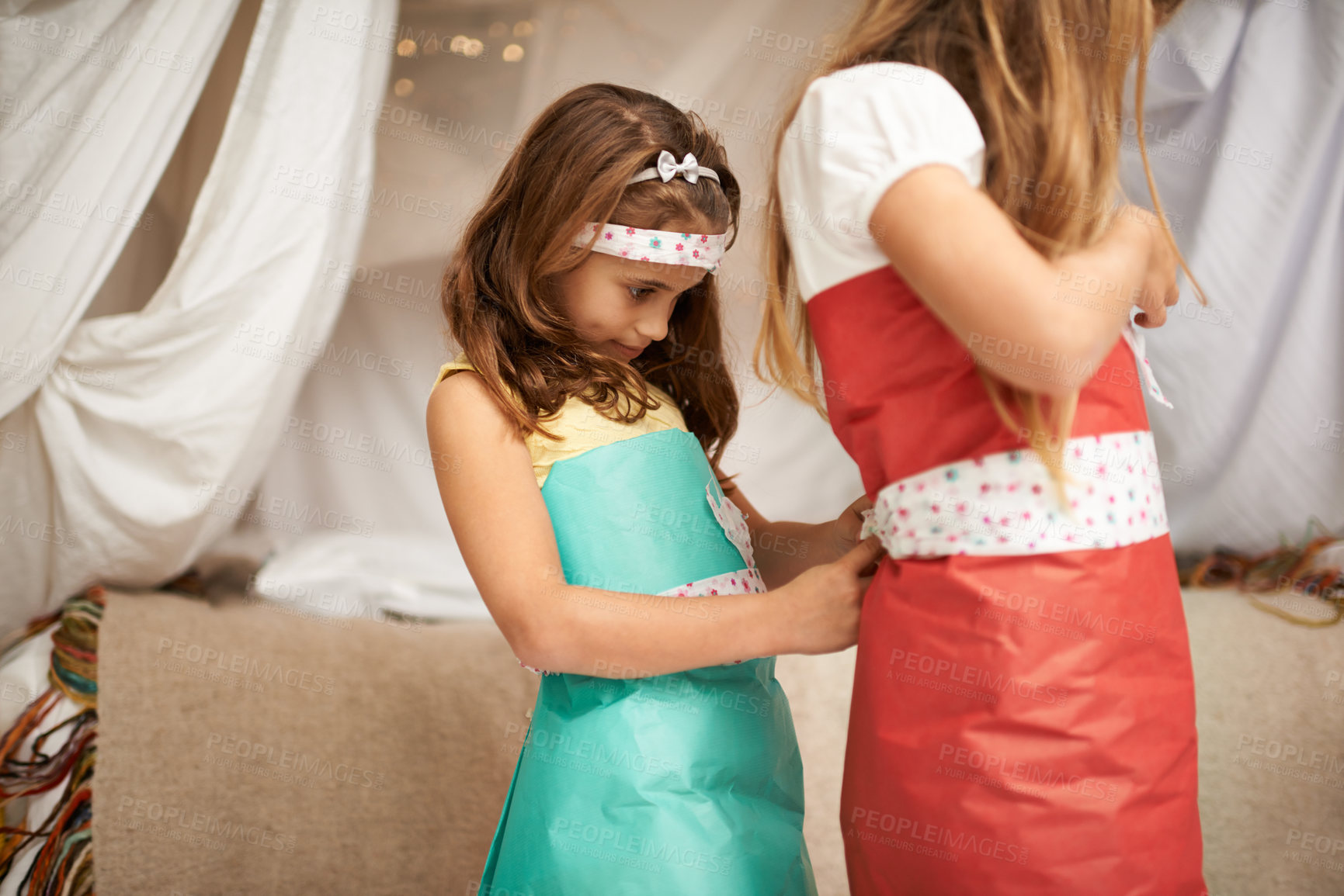 Buy stock photo Children, play and costume for dress, game and fun in house with wrapping for bonding and creative. Sibling, sister or kid for friendship, help and clothes for childhood, innocent and adorable