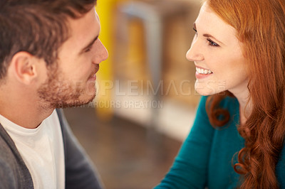 Buy stock photo Couple, smile and romance with eye contact in cafe, support and happiness for peace in relationship. Adult, woman and girl with love for man or partner in coffee shop and joy for marriage with guy