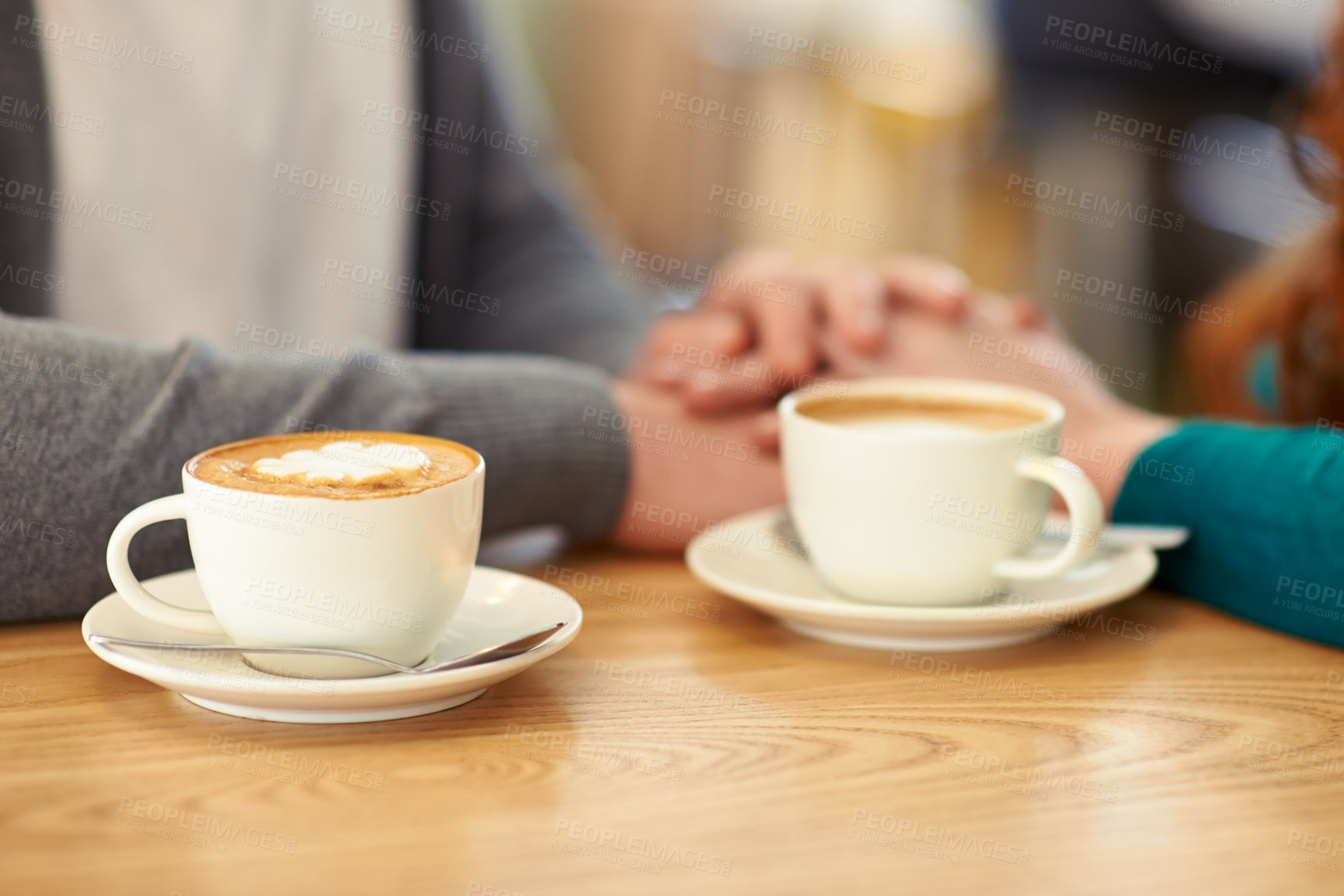Buy stock photo A cropped shot of a young affectionate couple on a coffee date