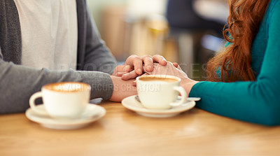 Buy stock photo Holding hands, coffee and couple in cafe, support and trust in relationship or marriage together. Diner, adult and partner with compassion, love and care for with respect on date, weekend and break