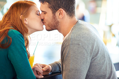 Buy stock photo Couple, date and kiss with romance, coffee shop or restaurant with happiness together. Man, woman and love for relationship, care and smile for flirting on break for relax or bonding in cafe